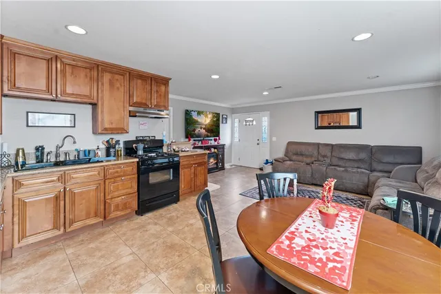 a kitchen with stainless steel appliances granite countertop a refrigerator sink and stove
