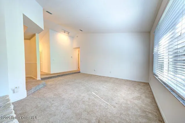 a view of a kitchen with wooden floor and a kitchen