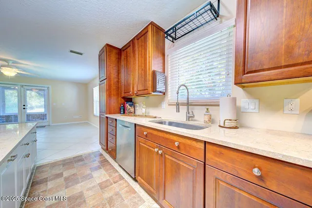 a kitchen with stainless steel appliances granite countertop a sink and a stove