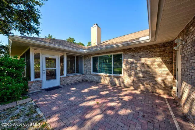 a view of a room with wooden floor and white walls