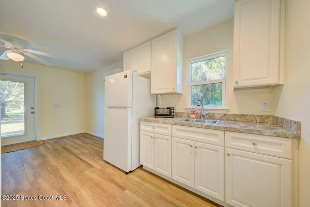 a view of a balcony with wooden floor and seating space