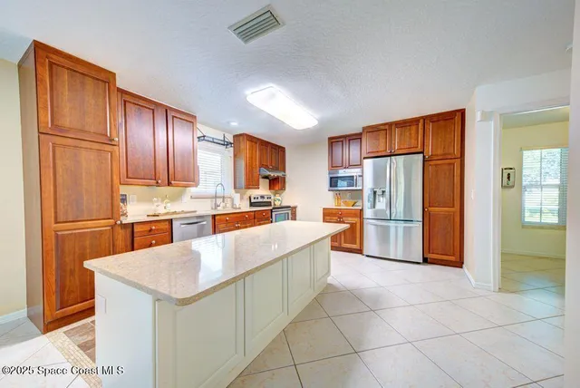 a kitchen with a sink cabinets and window