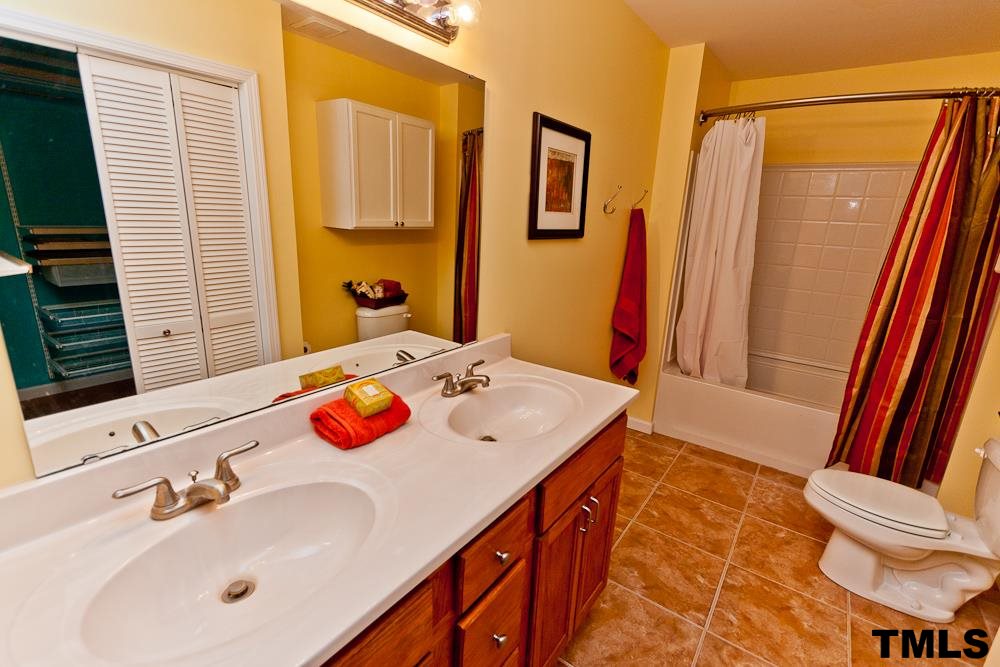 4305 Hopson Drive Raleigh, NC 27604 - Photo 8 of 14 Owner's bath with dual vanities, shower/tub combo.