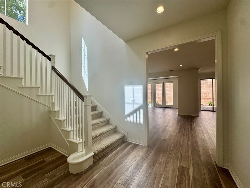 51 Elmdale Irvine, CA 92620 - Photo 11 of 41 a view of a hallway with wooden floor and staircase