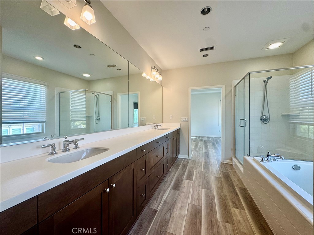 51 Elmdale Irvine, CA 92620 - Photo 24 of 41 a spacious bathroom with a double vanity sink and mirror with shower