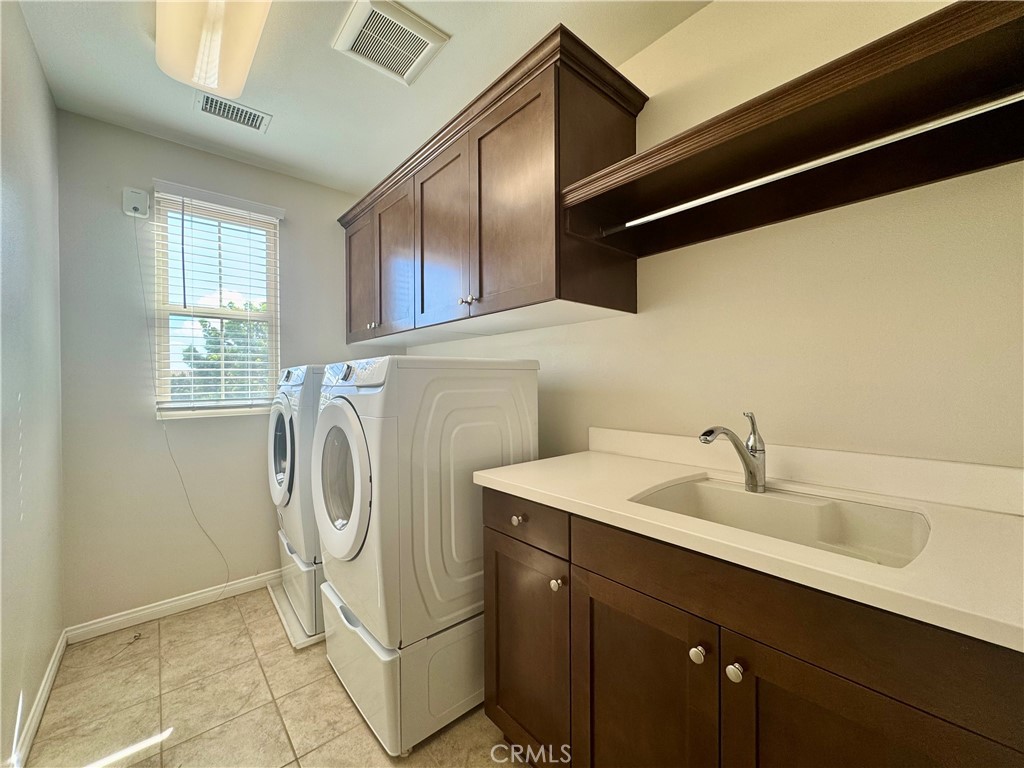 51 Elmdale Irvine, CA 92620 - Photo 31 of 41 a utility room with a sink a washer and dryer
