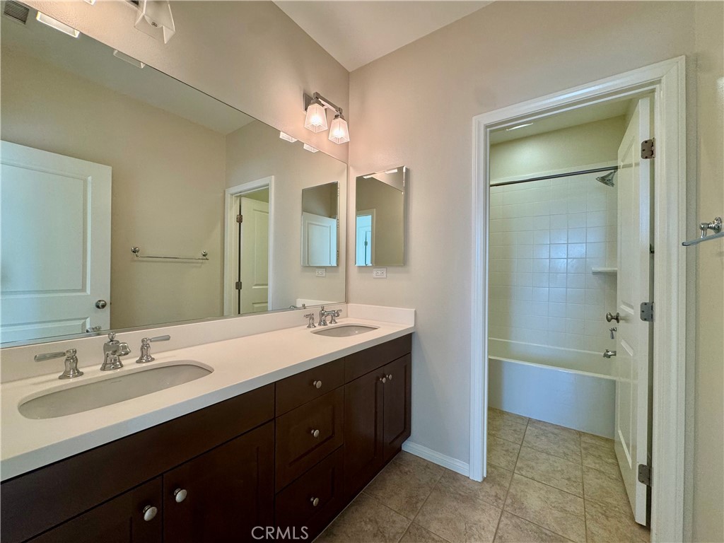 51 Elmdale Irvine, CA 92620 - Photo 32 of 41 a bathroom with a double vanity sink mirror and a shower