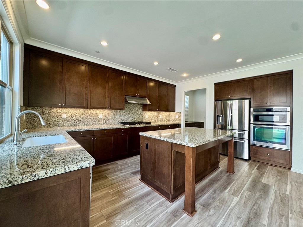 51 Elmdale Irvine, CA 92620 - Photo 7 of 41 a kitchen with stainless steel appliances granite countertop a stove a sink and a refrigerator