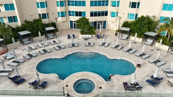 a view of a swimming pool with chairs