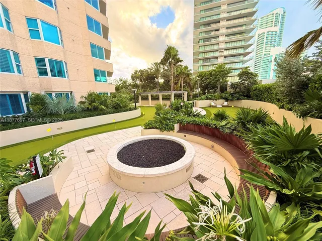 a view of a patio with a table and chairs and potted plants