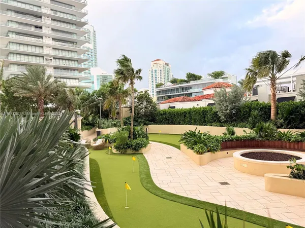 a view of a palm trees front of house