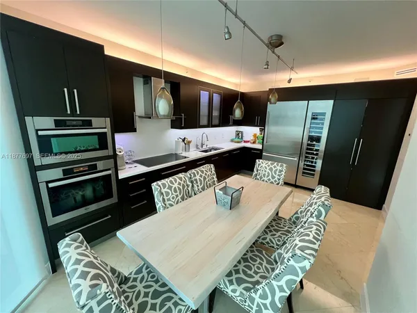 a large kitchen with a table and chairs