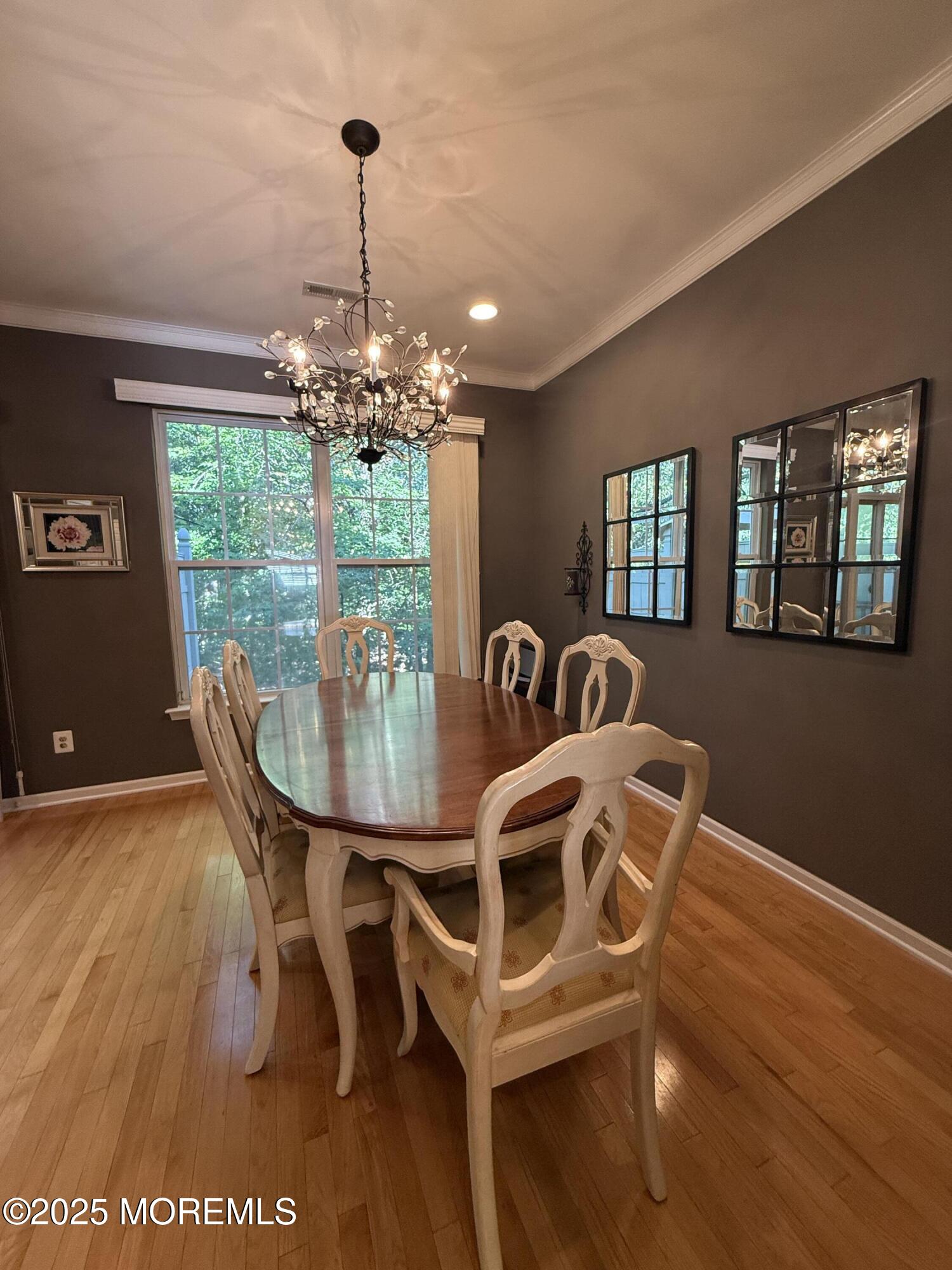 4 Pine Tree Terrace Holmdel, NJ 07733 - Photo 13 of 35 a view of a dining room with furniture a chandelier and wooden floor