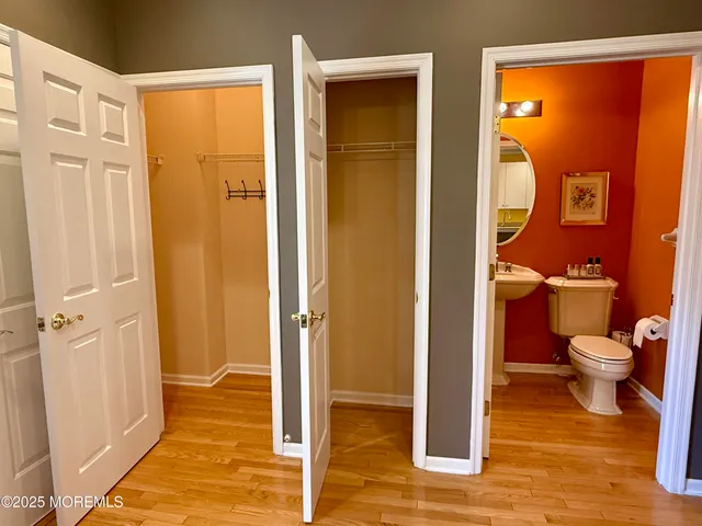 a bathroom with a glass door shower and a toilet
