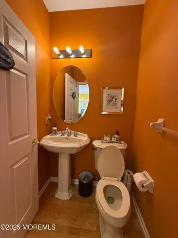 a bathroom with a sink mirror and toilet