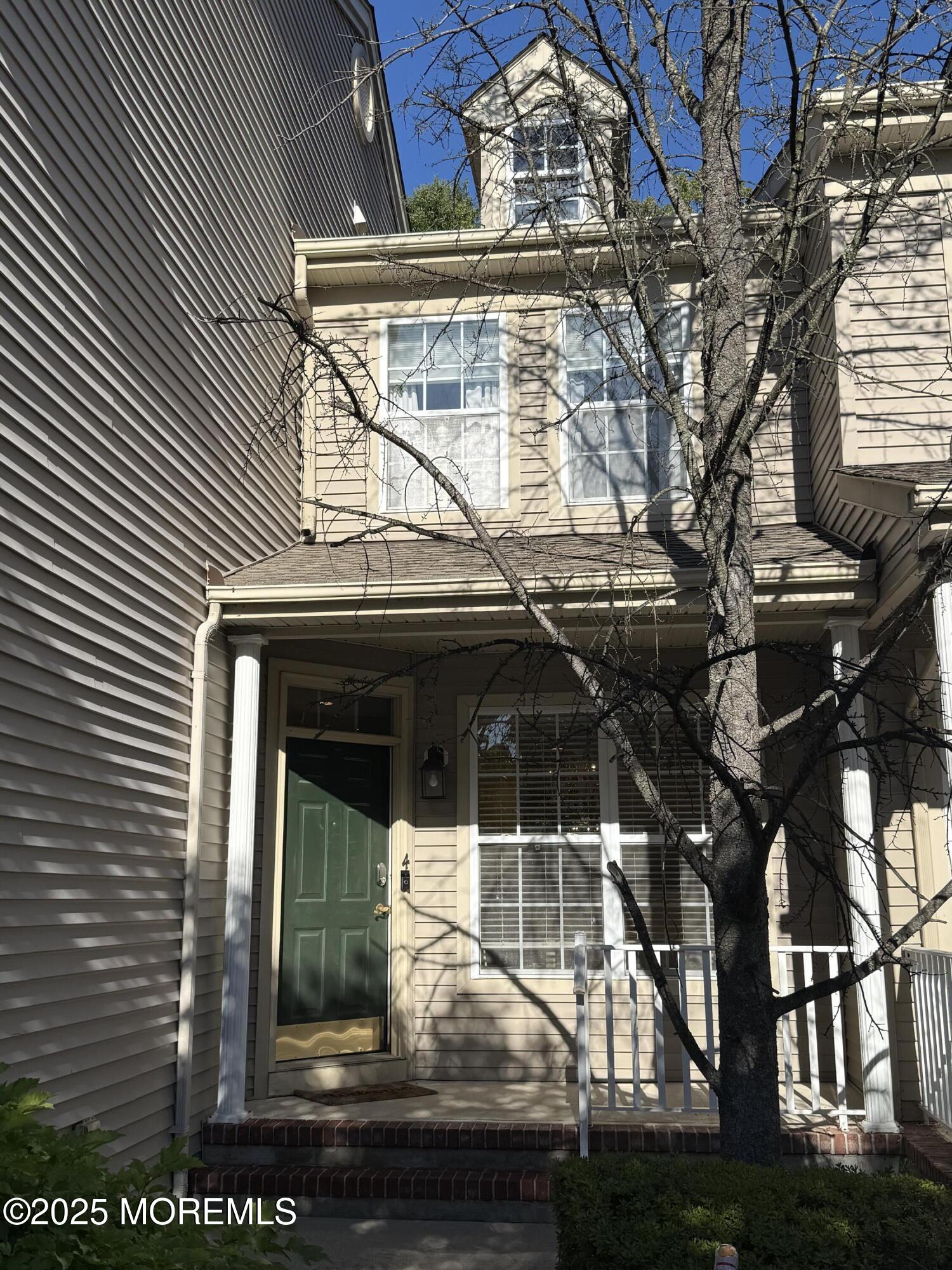 4 Pine Tree Terrace Holmdel, NJ 07733 - Photo 2 of 35 a front view of a house with a yard