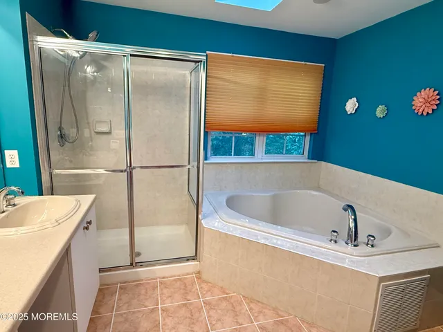 a bathroom with a tub and a sink