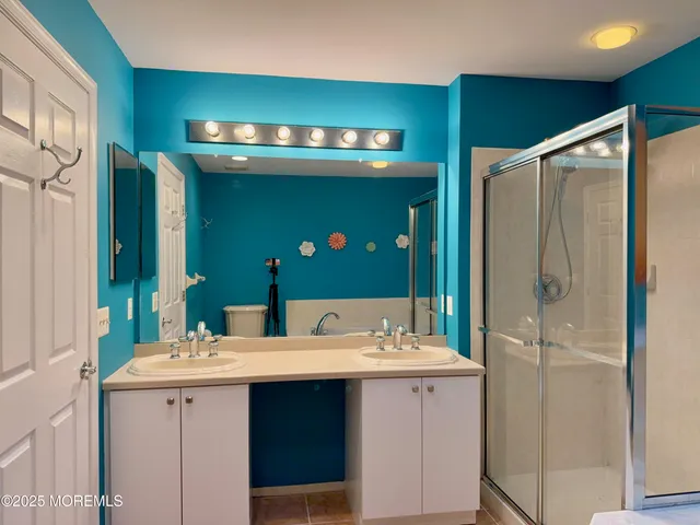 a bathroom with a sink double vanity and a mirror