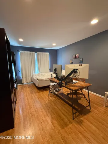 a living room with furniture pool table and a flat screen tv