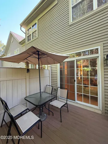 a balcony with table and chairs