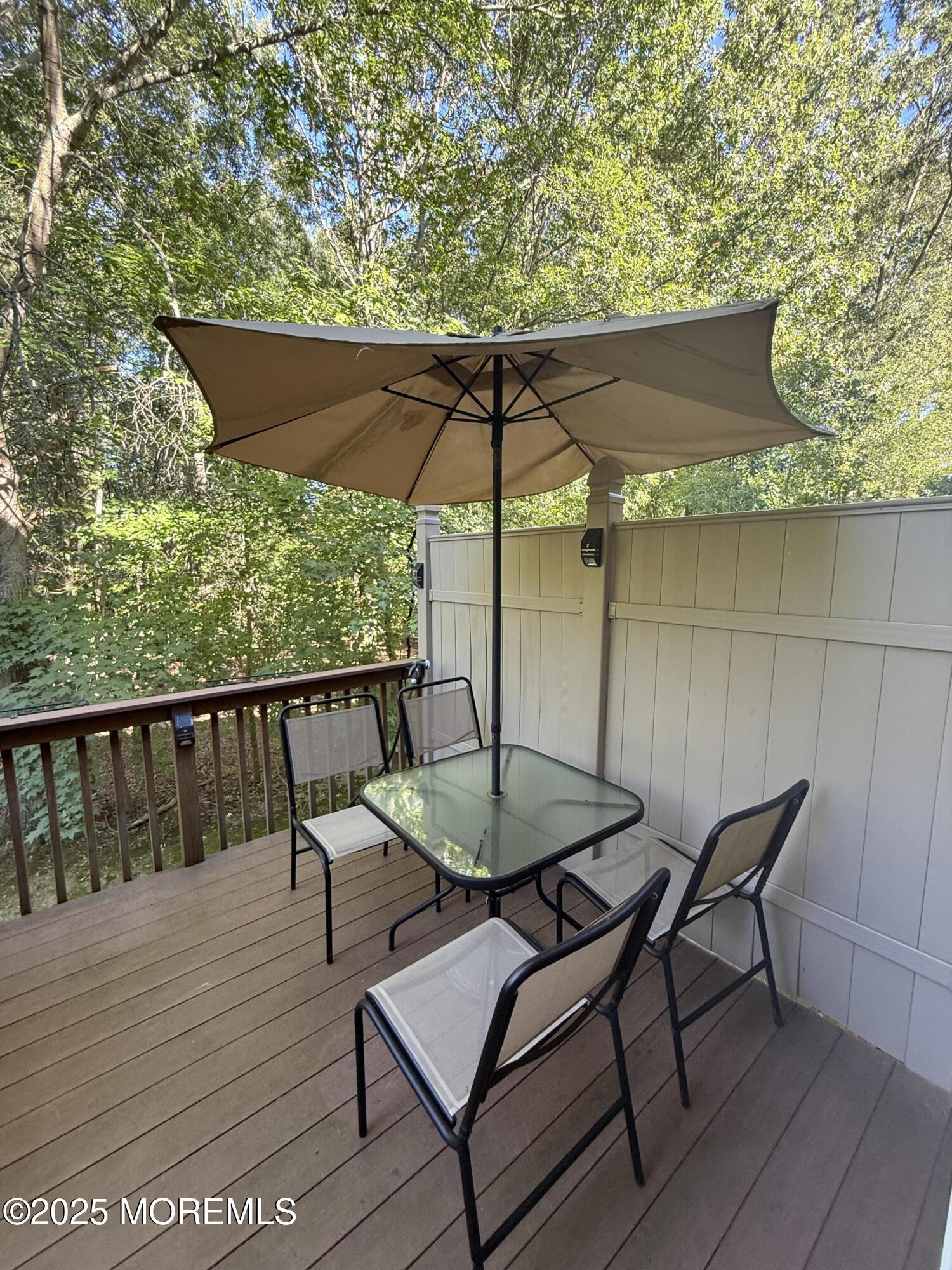 4 Pine Tree Terrace Holmdel, NJ 07733 - Photo 35 of 35 a balcony with table and chairs