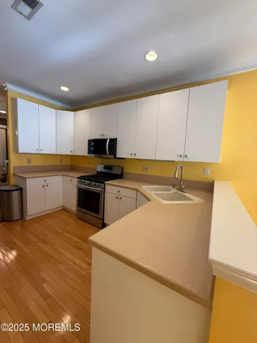 a kitchen with a sink and cabinets