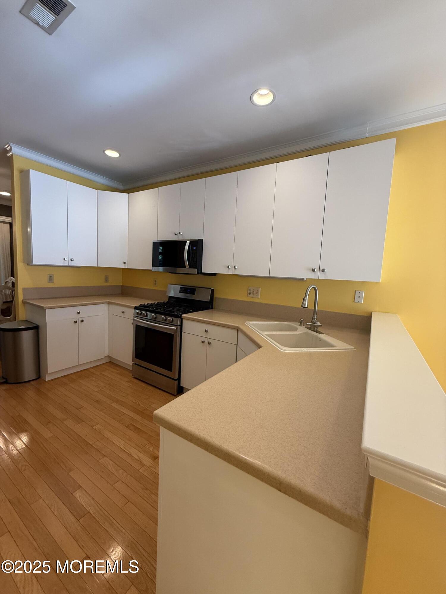 4 Pine Tree Terrace Holmdel, NJ 07733 - Photo 9 of 35 a kitchen with a sink and cabinets