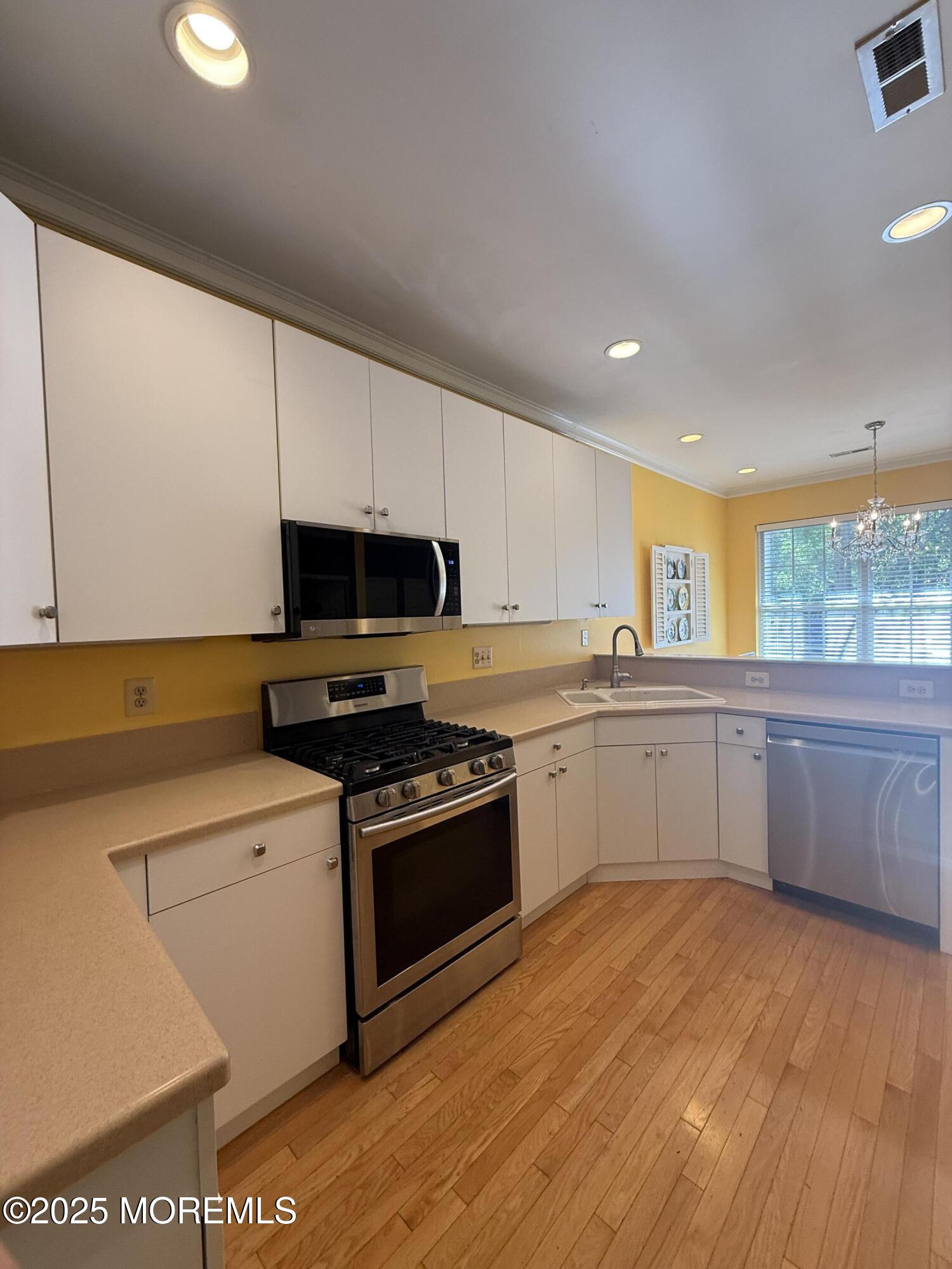 4 Pine Tree Terrace Holmdel, NJ 07733 - Photo 10 of 35 a kitchen with stainless steel appliances granite countertop a stove a sink and a microwave