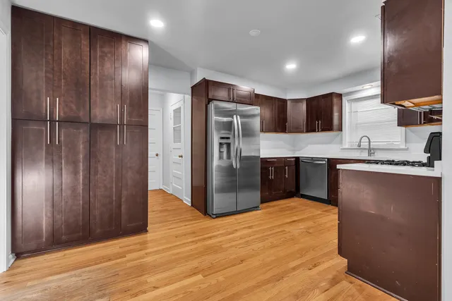 a kitchen with stainless steel appliances granite countertop a refrigerator and a sink