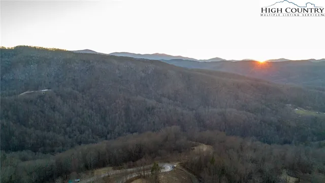 a view of a dry yard with mountains in the background
