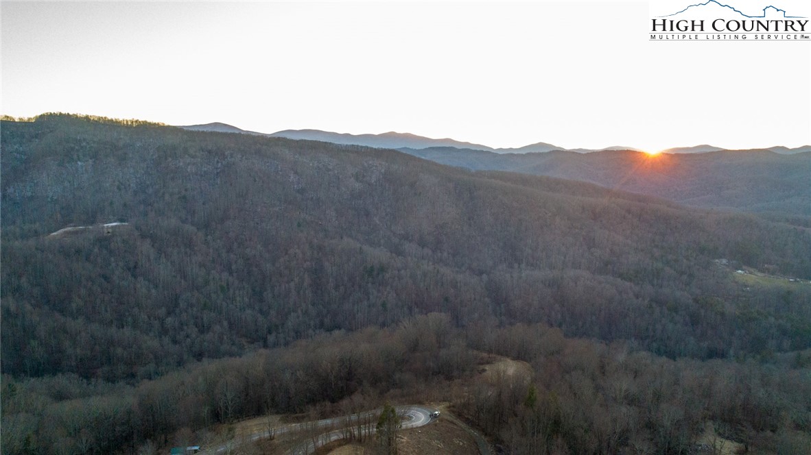 0 Dark Ridge Road Elk Park, NC 28622 - Photo 5 of 22 a view of a dry yard with mountains in the background