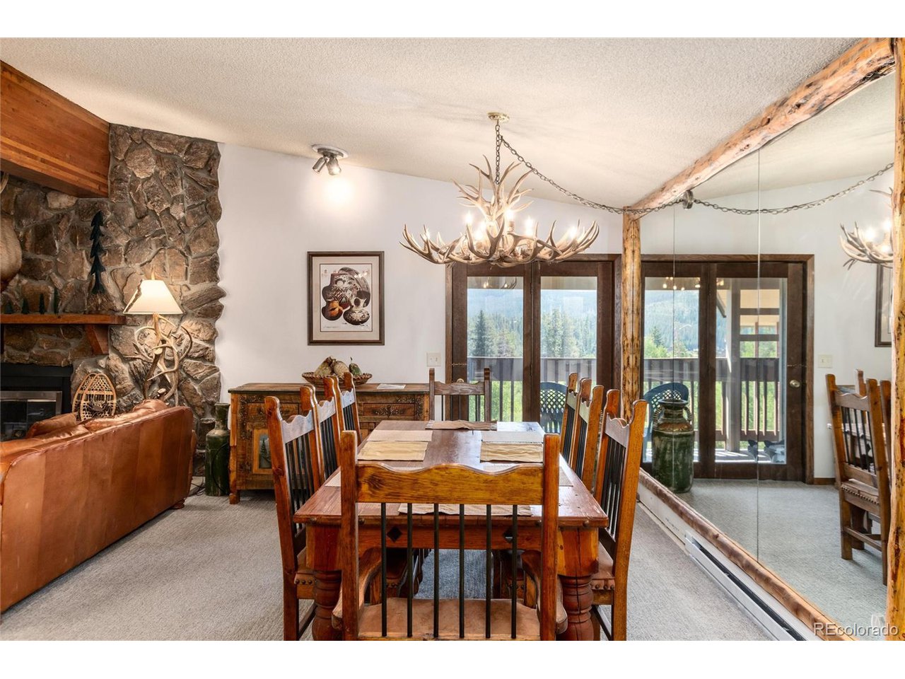 490 Kings Crossing Road, Unit 631 Winter Park, CO 80482 - Photo 10 of 43 a view of a dining room with furniture a chandelier and large windows