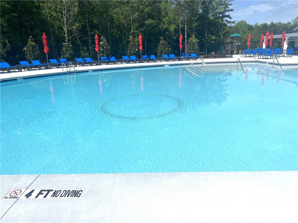 1191 Amerson Street Buckhead, GA 30625 - Photo 11 of 96 a view of swimming pool with outdoor seating and covered with trees
