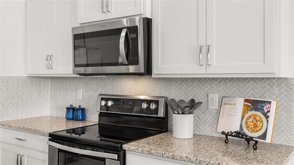 1191 Amerson Street Buckhead, GA 30625 - Photo 28 of 96 a kitchen with stainless steel appliances granite countertop a stove a microwave and cabinets