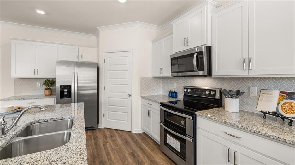 1191 Amerson Street Buckhead, GA 30625 - Photo 29 of 96 a kitchen with granite countertop a sink stove and refrigerator