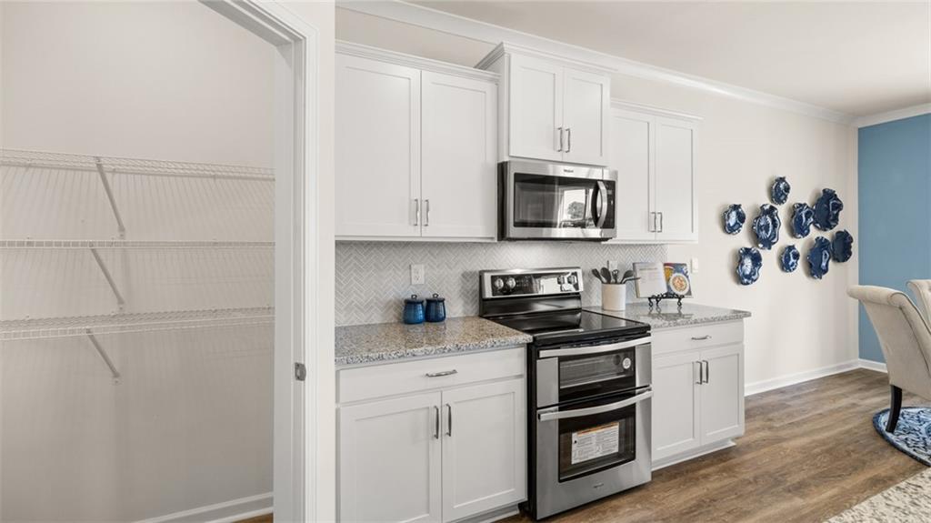 1191 Amerson Street Buckhead, GA 30625 - Photo 31 of 96 a kitchen with stainless steel appliances white cabinets and a stove top oven