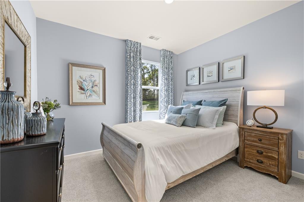 1191 Amerson Street Buckhead, GA 30625 - Photo 41 of 96 a bedroom with a bed and a potted plant