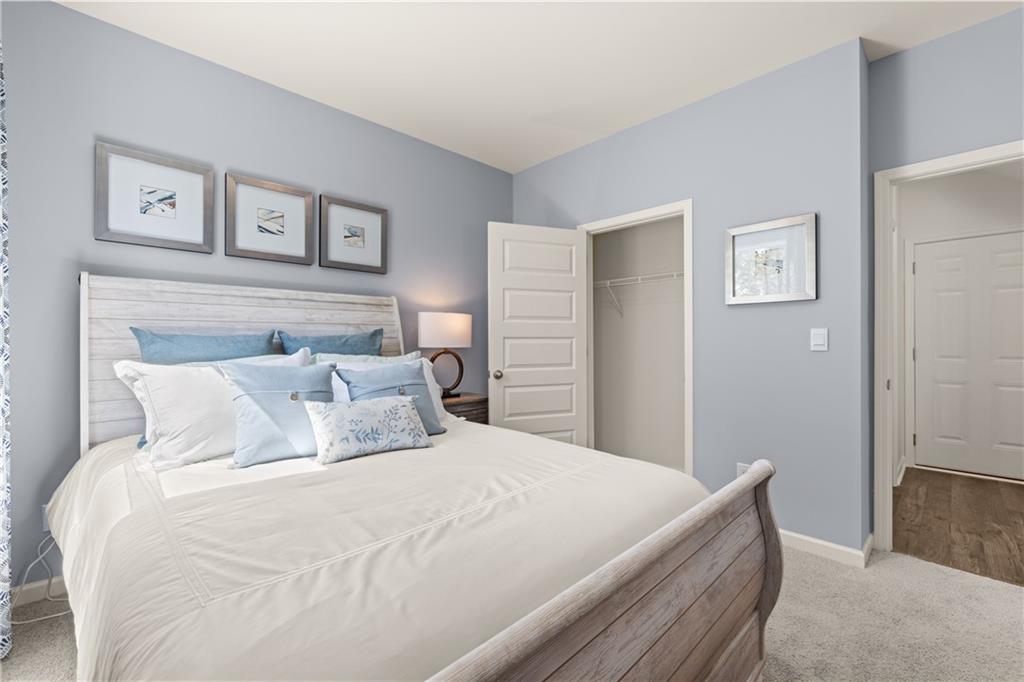 1191 Amerson Street Buckhead, GA 30625 - Photo 43 of 96 a bedroom with a large bed and a chandelier