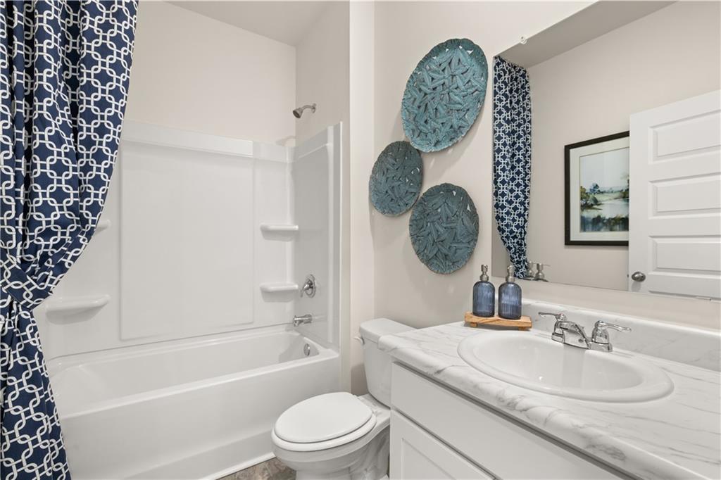 1191 Amerson Street Buckhead, GA 30625 - Photo 45 of 96 a bathroom with a granite countertop toilet a sink and a mirror