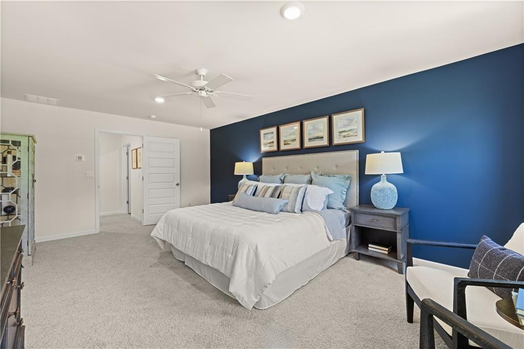 1191 Amerson Street Buckhead, GA 30625 - Photo 51 of 96 a bedroom with a bed and a chandelier