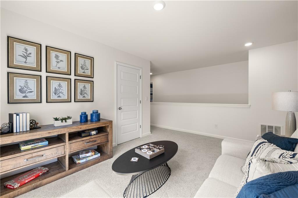1191 Amerson Street Buckhead, GA 30625 - Photo 61 of 96 a living room with furniture and a baby crib with wooden floor