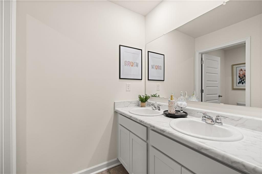 1191 Amerson Street Buckhead, GA 30625 - Photo 75 of 96 a bathroom with a double vanity sink and a mirror