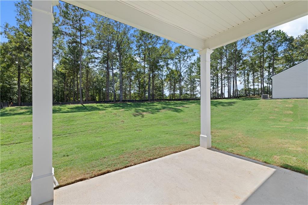 1191 Amerson Street Buckhead, GA 30625 - Photo 84 of 96 a view of a grassy field with trees in the background