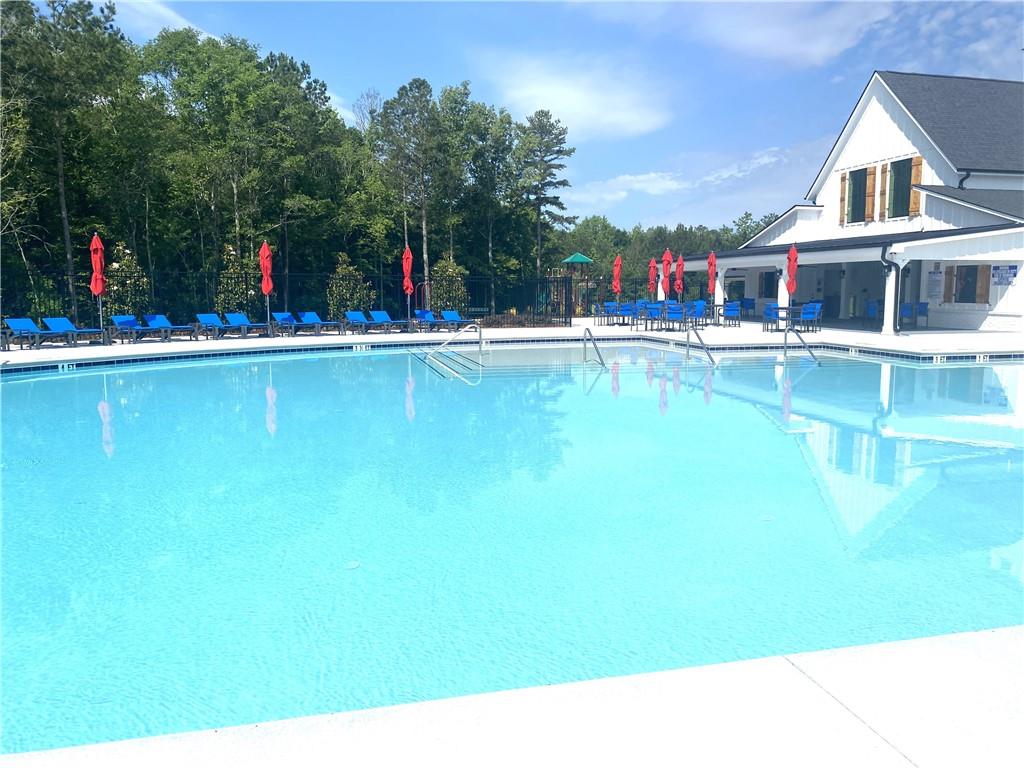 1191 Amerson Street Buckhead, GA 30625 - Photo 10 of 96 a view of swimming pool with outdoor seating and house in the background