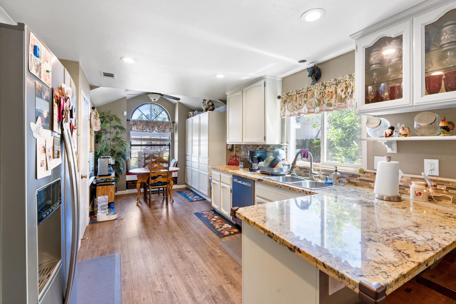 116 Fern Court Galt, CA 95632 - Photo 11 of 44 a kitchen with stainless steel appliances granite countertop a refrigerator a sink and wooden floors