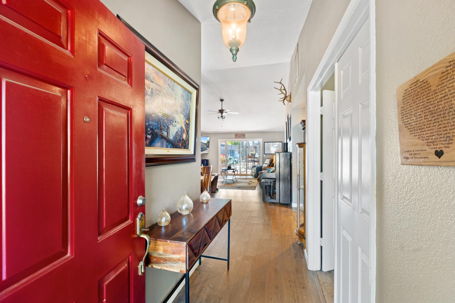 116 Fern Court Galt, CA 95632 - Photo 13 of 44 a view of a hallway with dining area wooden floor and a chandelier