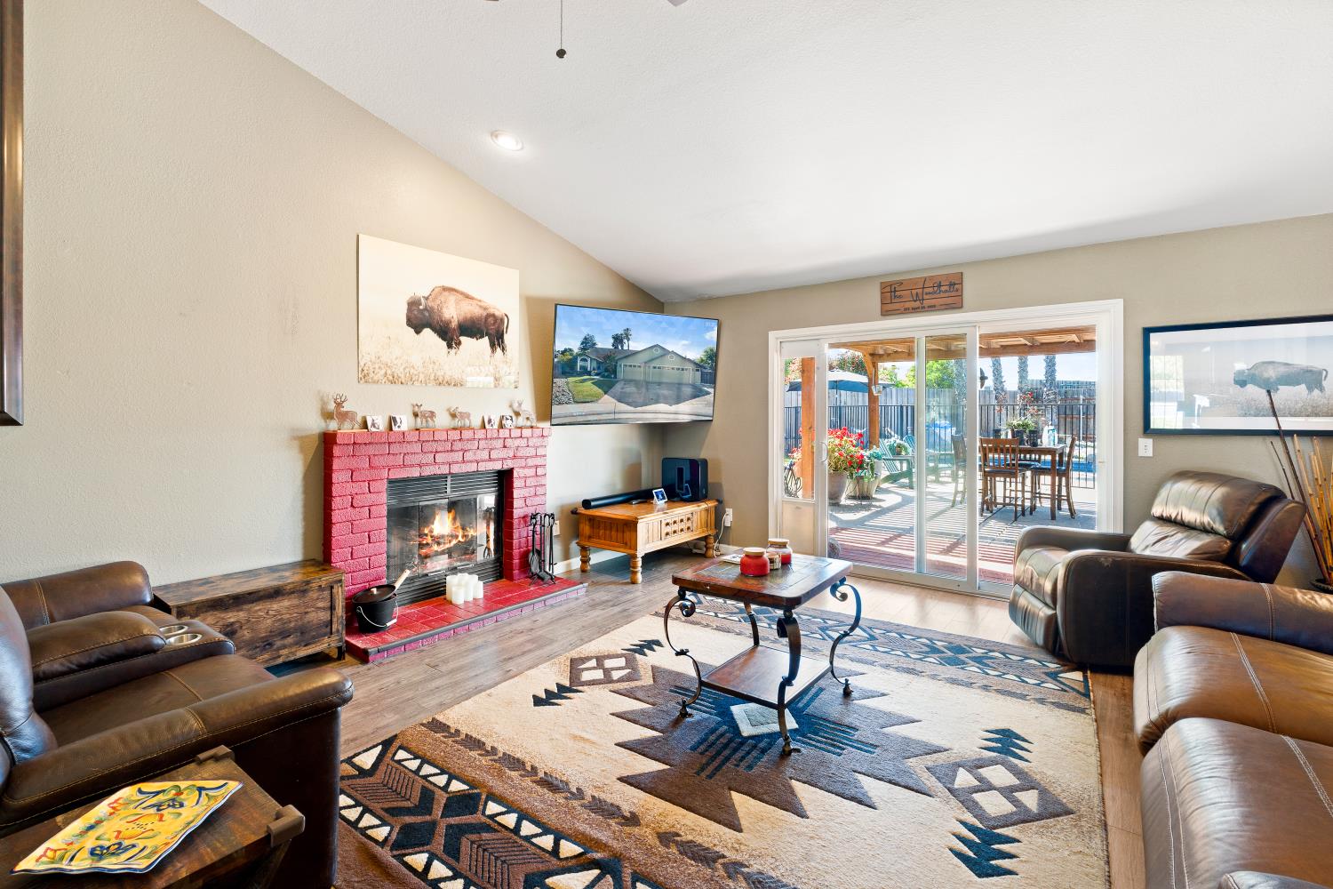 116 Fern Court Galt, CA 95632 - Photo 16 of 44 a living room with furniture a fireplace and a floor to ceiling window