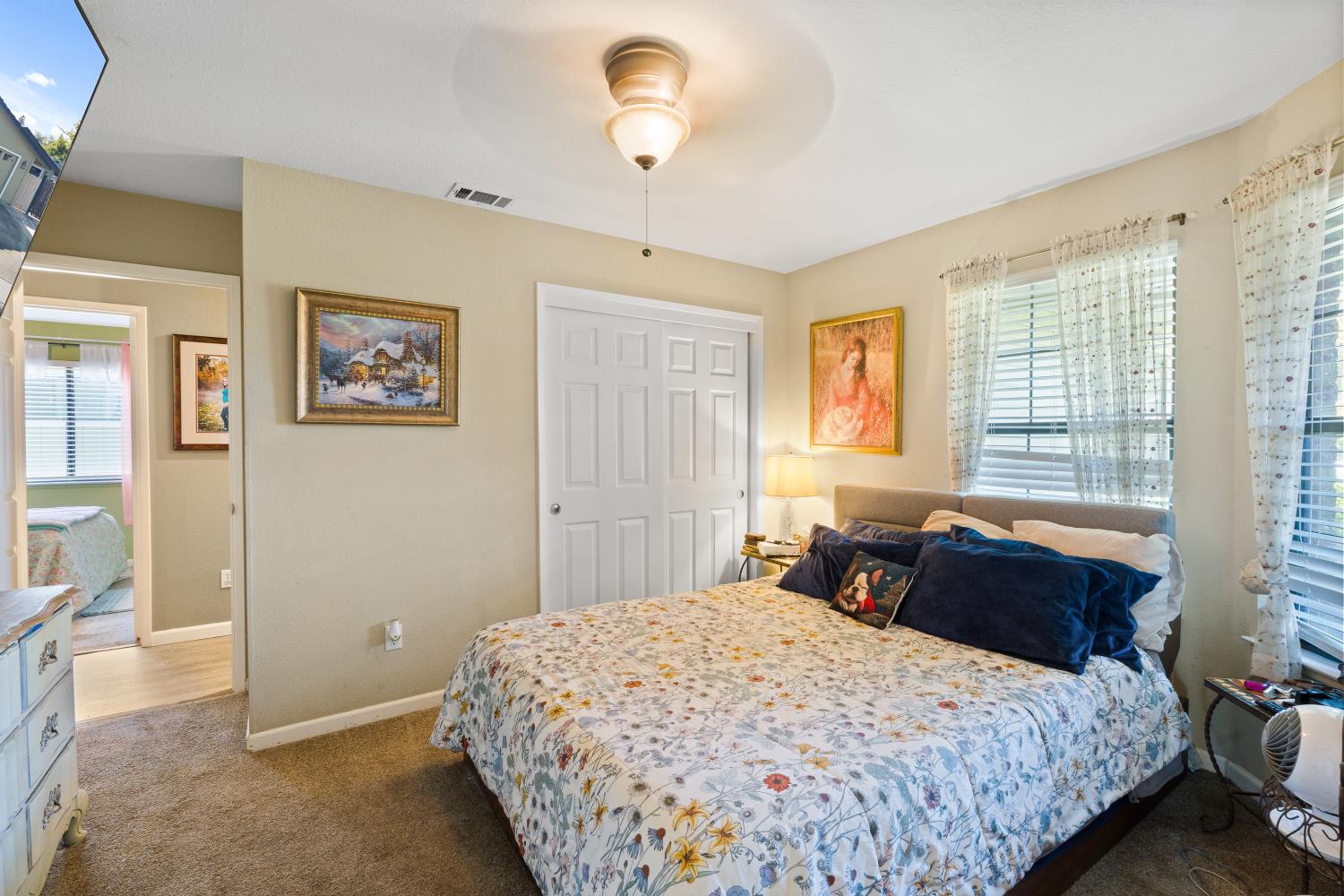 116 Fern Court Galt, CA 95632 - Photo 22 of 44 a bedroom with a large bed and a chandelier