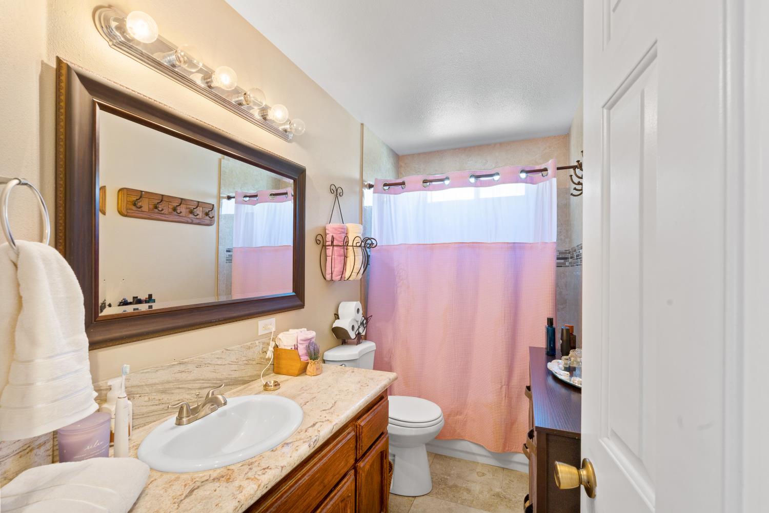 116 Fern Court Galt, CA 95632 - Photo 25 of 44 a bath room with a sink and a mirror