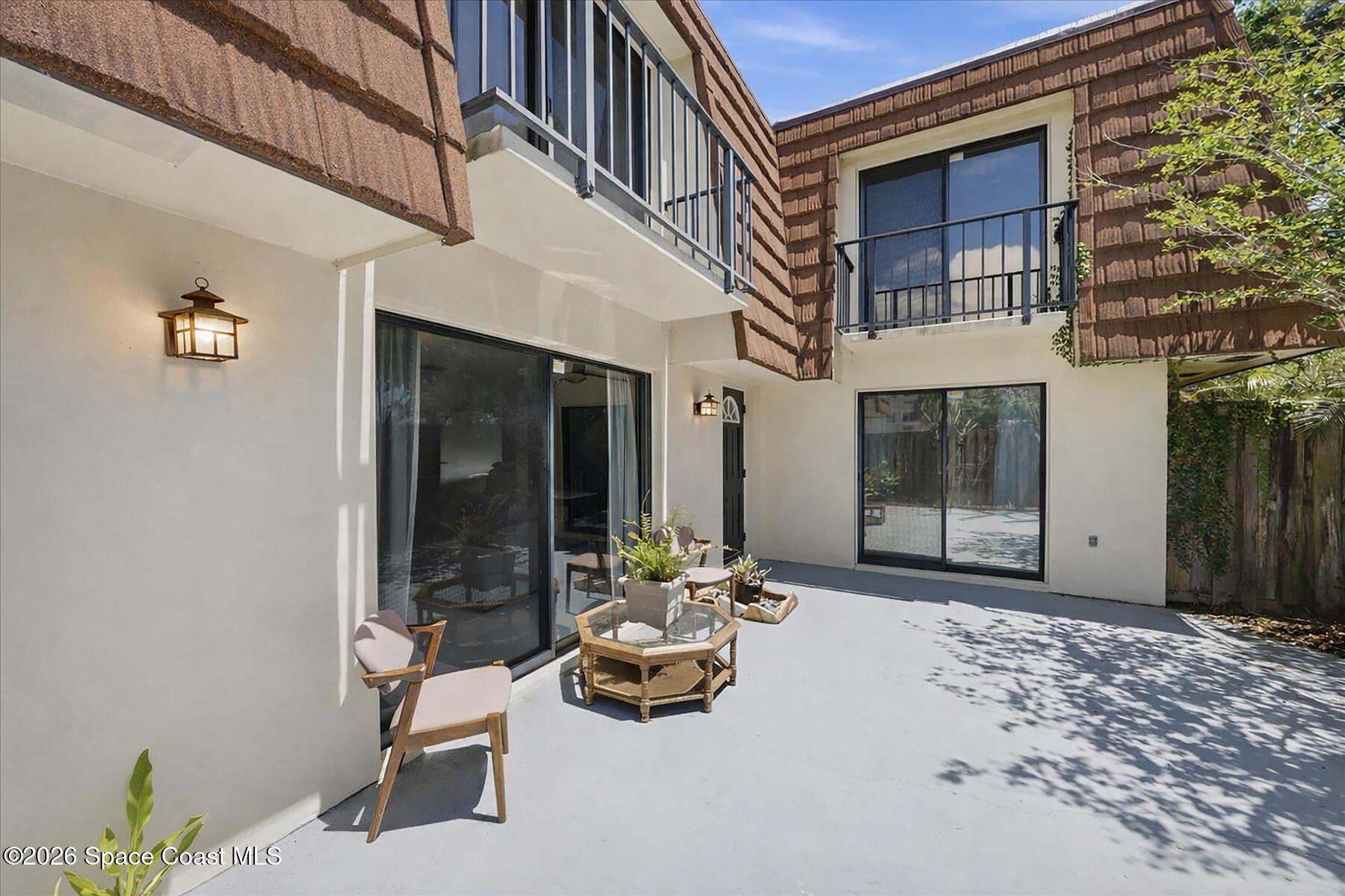 a building outdoor space with patio furniture and white walls